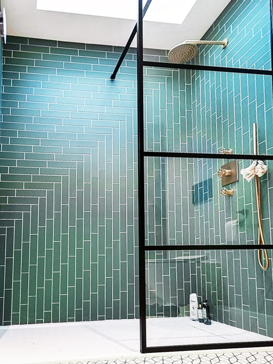 Shower ensuite herringbone green wall tiling